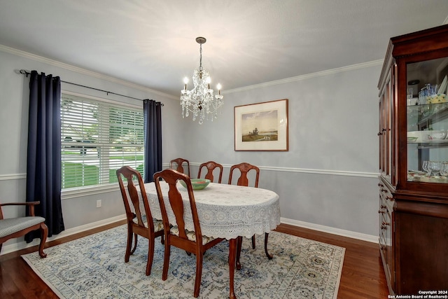 dining room featuring crown molding, dark wood-type flooring, and a chandelier