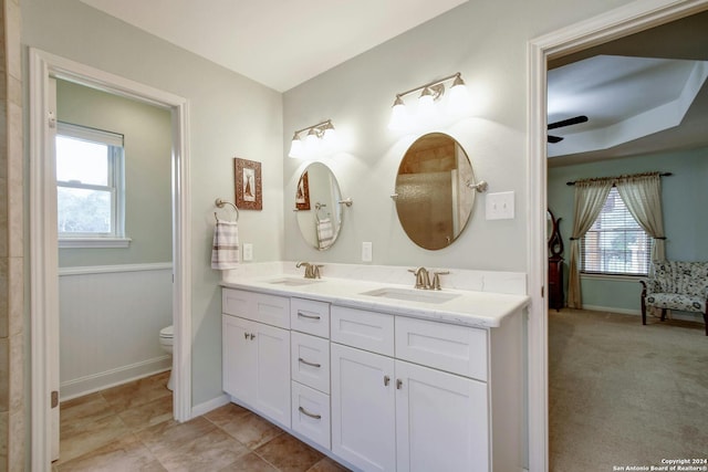 bathroom with vanity, a wealth of natural light, ceiling fan, and toilet