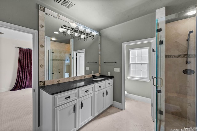 bathroom with vanity, an enclosed shower, and toilet