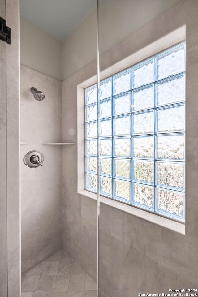 bathroom with tiled shower