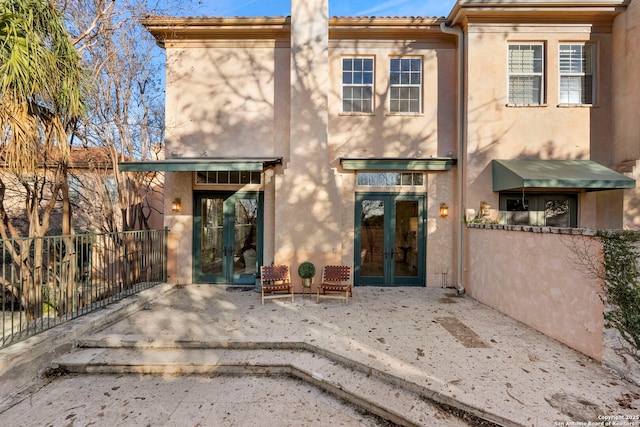 back of property featuring a patio area and french doors