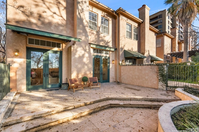 back of house featuring a patio and french doors