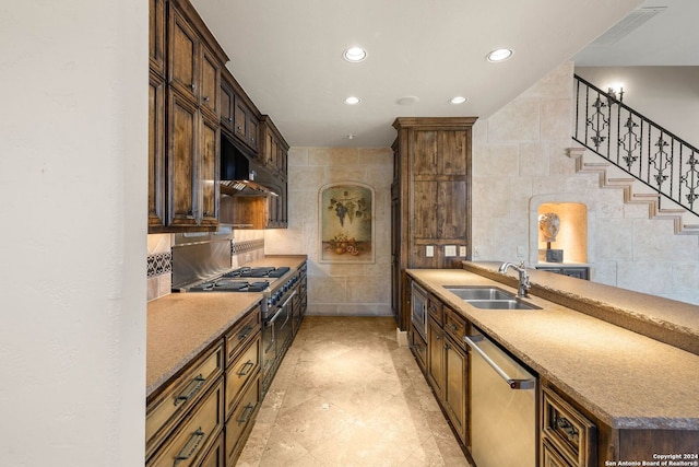 kitchen featuring tile walls, sink, and stainless steel appliances