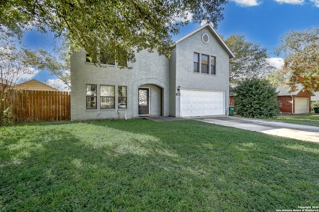 traditional home with a garage, concrete driveway, fence, a front lawn, and brick siding