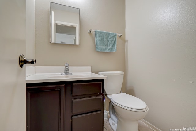 bathroom featuring tile patterned flooring, vanity, and toilet