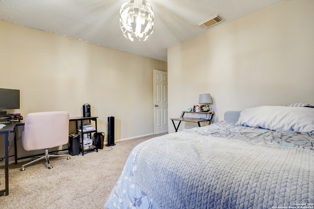 carpeted bedroom featuring a textured ceiling and a chandelier