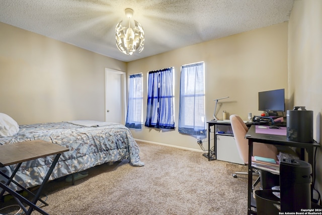 bedroom with a textured ceiling, carpet floors, and an inviting chandelier