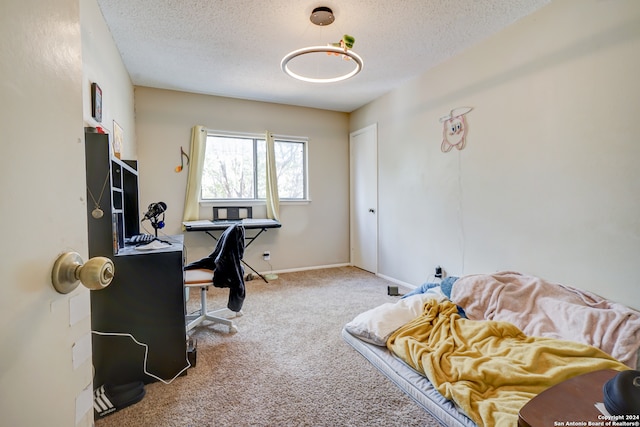 carpeted home office with a textured ceiling