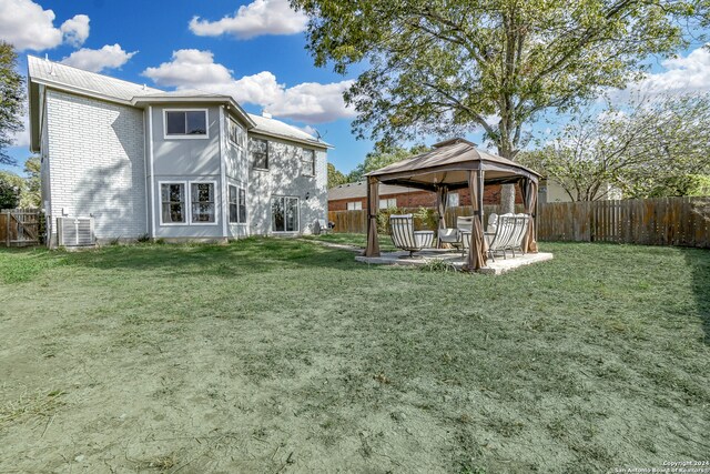 view of yard with a gazebo, central air condition unit, and a patio