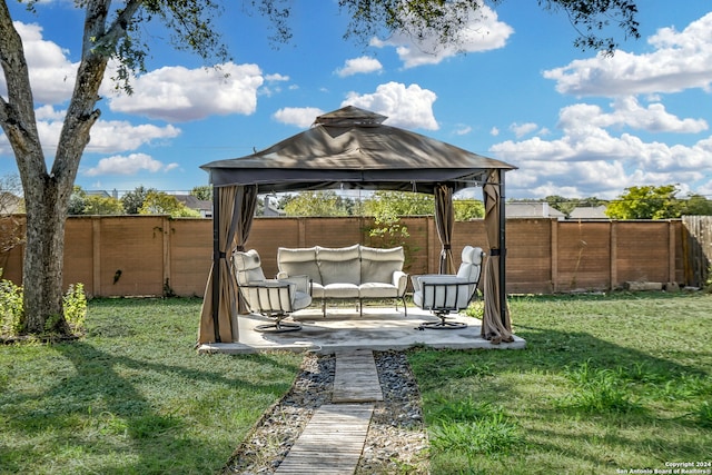 view of yard featuring a gazebo, an outdoor hangout area, and a patio