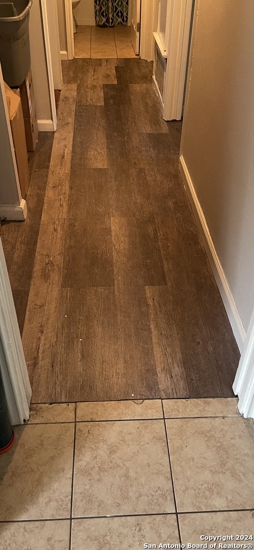 corridor with dark hardwood / wood-style floors