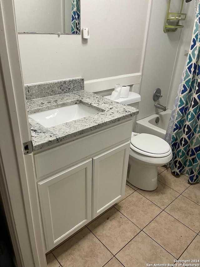 full bathroom featuring tile patterned flooring, vanity, toilet, and shower / tub combo with curtain