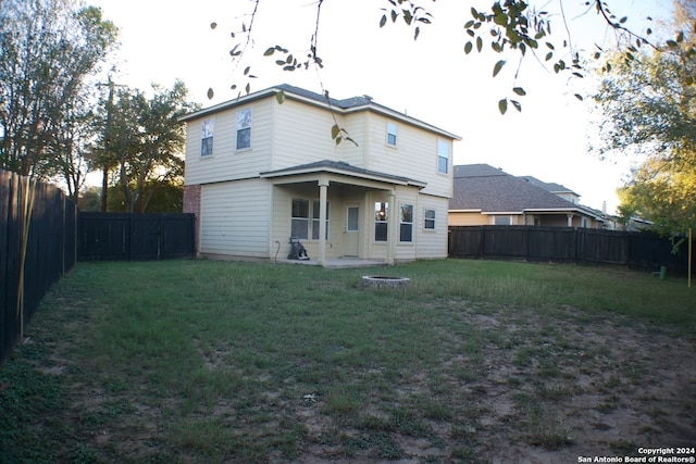 rear view of property with a yard