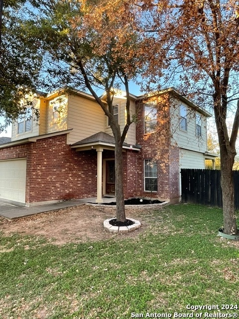 rear view of property with a lawn and a garage