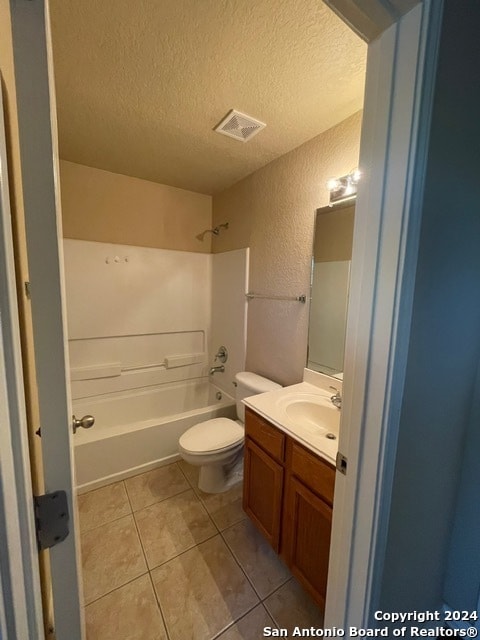 full bathroom with vanity,  shower combination, tile patterned flooring, toilet, and a textured ceiling