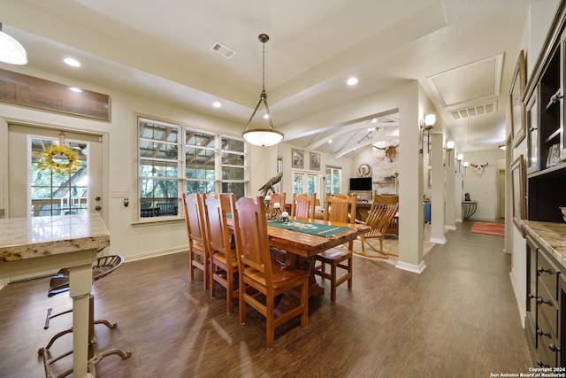 dining area with dark hardwood / wood-style flooring and lofted ceiling with beams