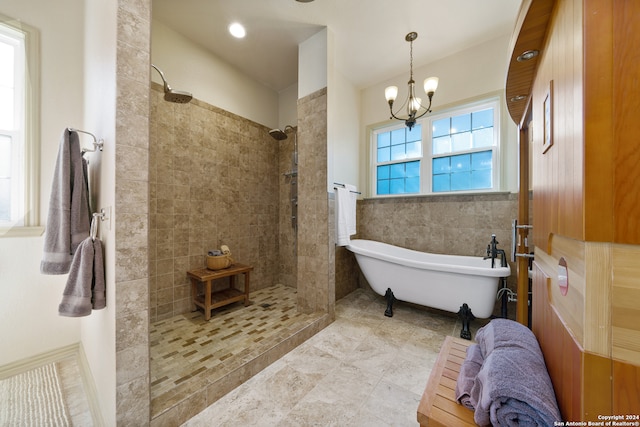 bathroom with tile patterned floors, plus walk in shower, and a chandelier