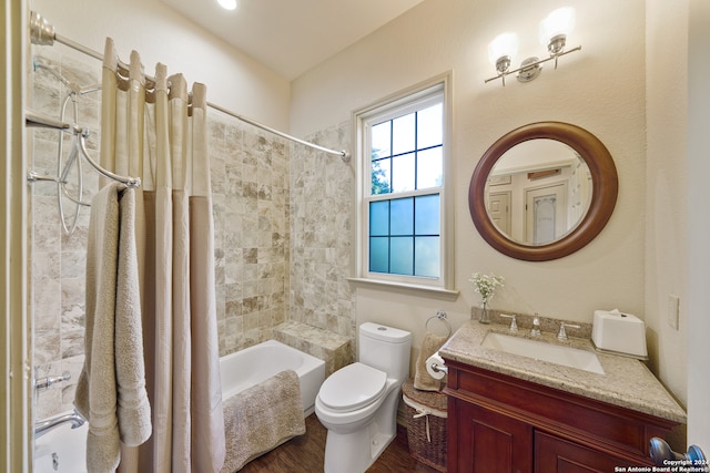 full bathroom featuring vanity, toilet, shower / bathtub combination with curtain, and hardwood / wood-style flooring