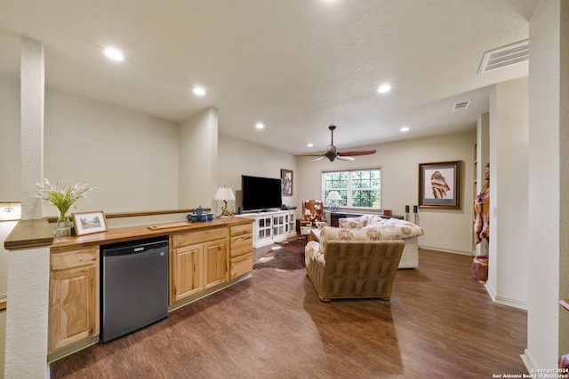 kitchen with light brown cabinets, stainless steel dishwasher, ceiling fan, dark hardwood / wood-style flooring, and butcher block counters