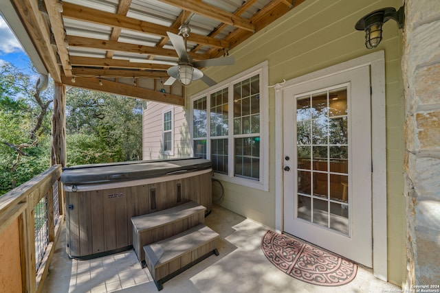 exterior space featuring a hot tub, ceiling fan, and a wooden deck