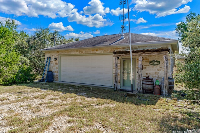 exterior space featuring an outdoor structure and a garage