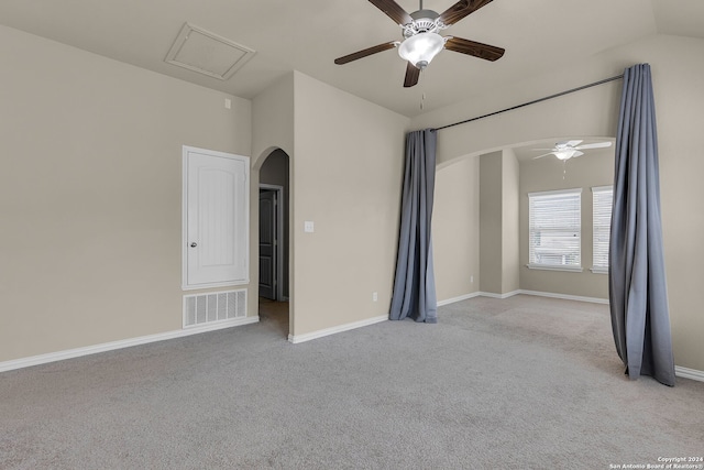 carpeted spare room with vaulted ceiling and ceiling fan