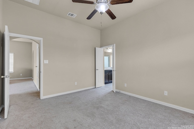 spare room featuring ceiling fan and light carpet