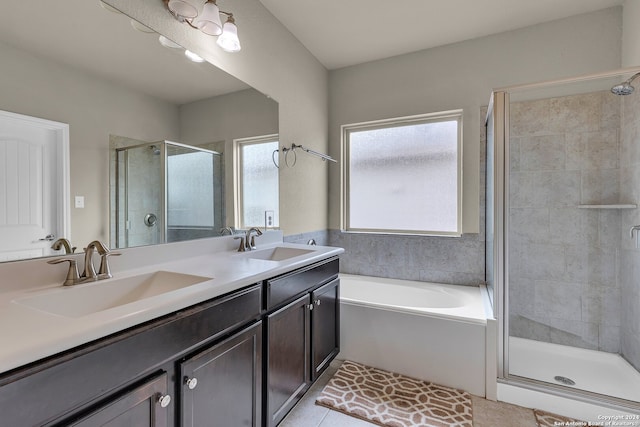 bathroom featuring tile patterned flooring, vanity, and plus walk in shower