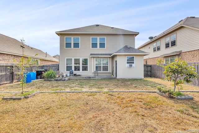 back of house featuring a patio area and a yard