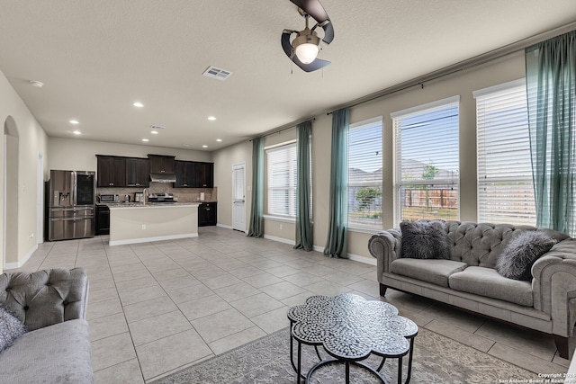 living room featuring light tile patterned floors and a textured ceiling