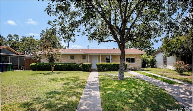 ranch-style home featuring a front yard