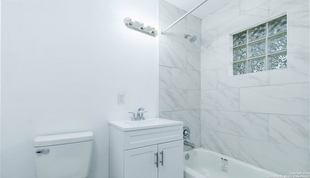 full bathroom featuring vanity, tiled shower / bath combo, and toilet