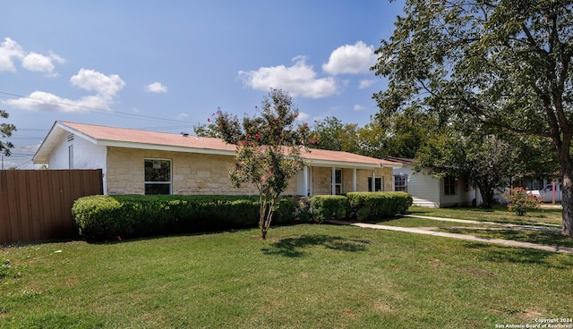 ranch-style home featuring a front yard