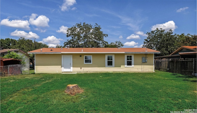 rear view of house with a yard