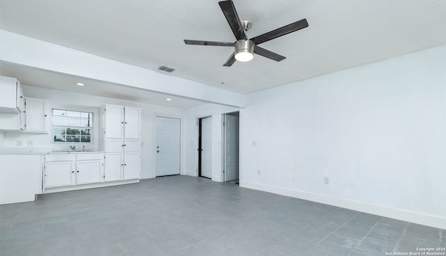 unfurnished living room featuring ceiling fan