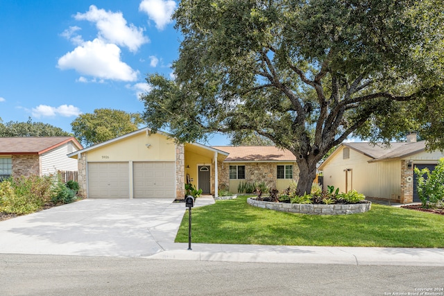 ranch-style home featuring a front yard and a garage