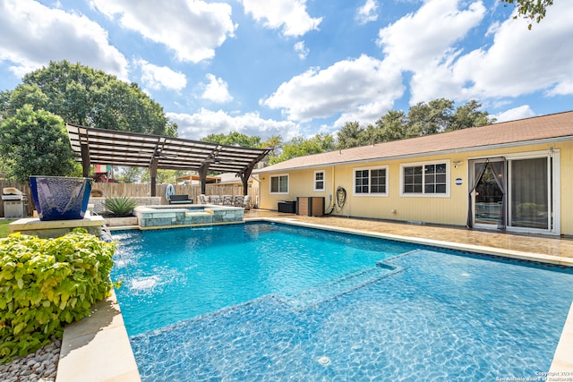 view of pool with an in ground hot tub, pool water feature, and a patio