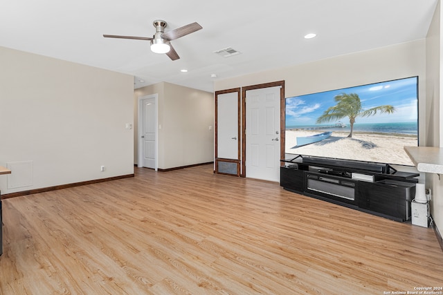 living room with light hardwood / wood-style floors and ceiling fan