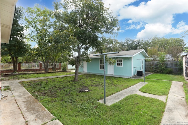 exterior space featuring a lawn and central AC unit