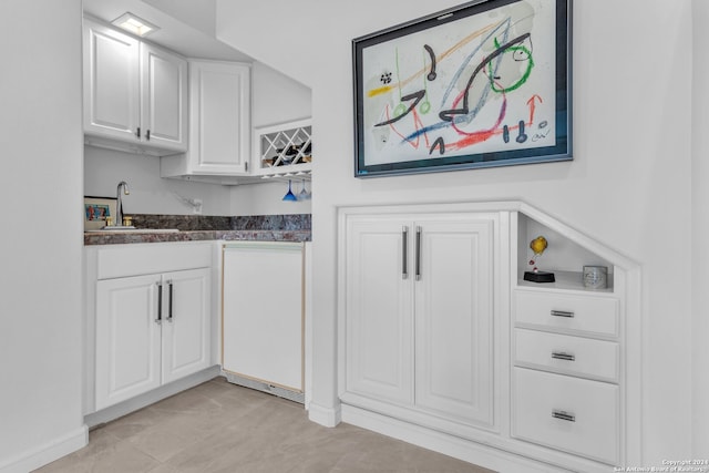 kitchen with white cabinetry and sink