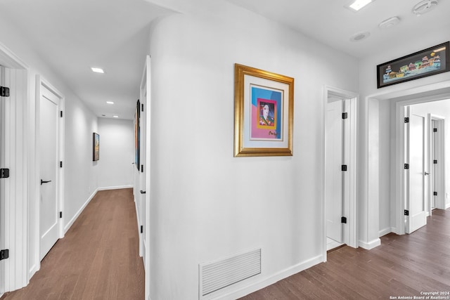 hallway with hardwood / wood-style flooring