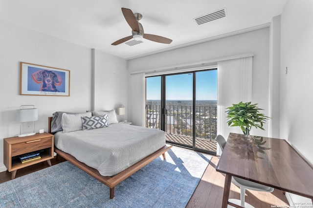 bedroom featuring access to outside, hardwood / wood-style flooring, and ceiling fan