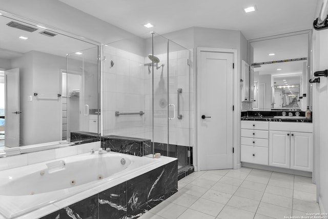 bathroom with tile patterned floors, vanity, and independent shower and bath