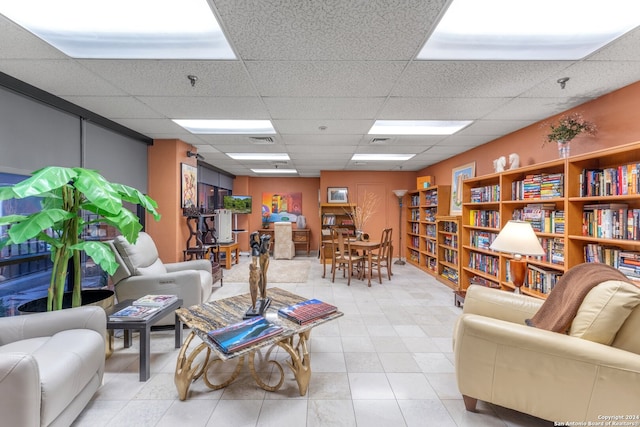 interior space with light tile patterned floors and a paneled ceiling