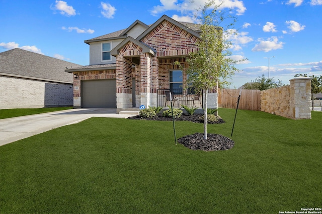 view of front facade with a garage and a front lawn