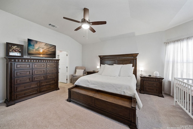 bedroom with ceiling fan, lofted ceiling, and light carpet