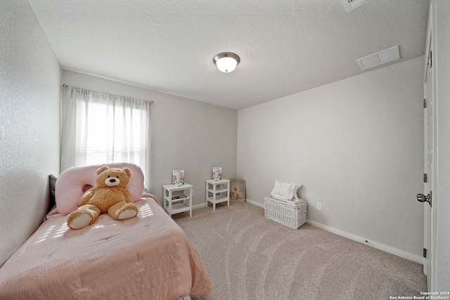 carpeted bedroom with a textured ceiling