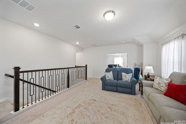 living room featuring light colored carpet and lofted ceiling