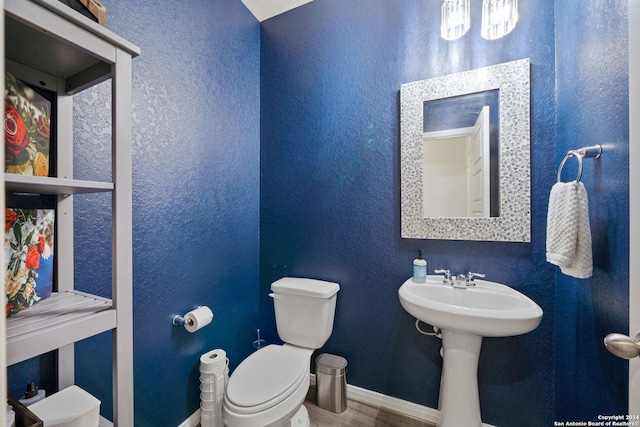 bathroom featuring hardwood / wood-style floors and toilet