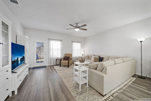 living room featuring ceiling fan and hardwood / wood-style flooring